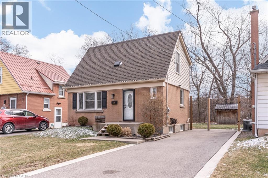 View of front of home with a shingled roof, a front yard, and brick siding - 624 Burgess Avenue, Hamilton, ON - Outdoor