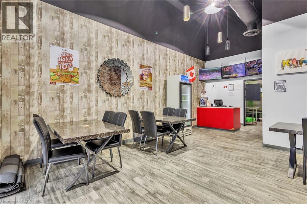 Commercial interior featuring wood-finish wall panels and complementary wood-finish flooring - 545 Hespeler Road, Cambridge, ON