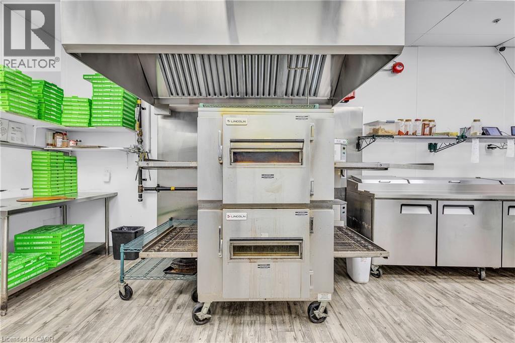 Commercial kitchen featuring stainless steel double-deck conveyor ovens - 545 Hespeler Road, Cambridge, ON