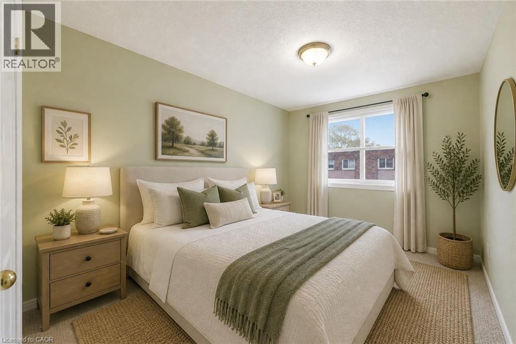 Bedroom with light green walls and carpeted flooring - 299 Limeridge Ridge W Unit# 21, Hamilton, ON - Indoor Photo Showing Bedroom