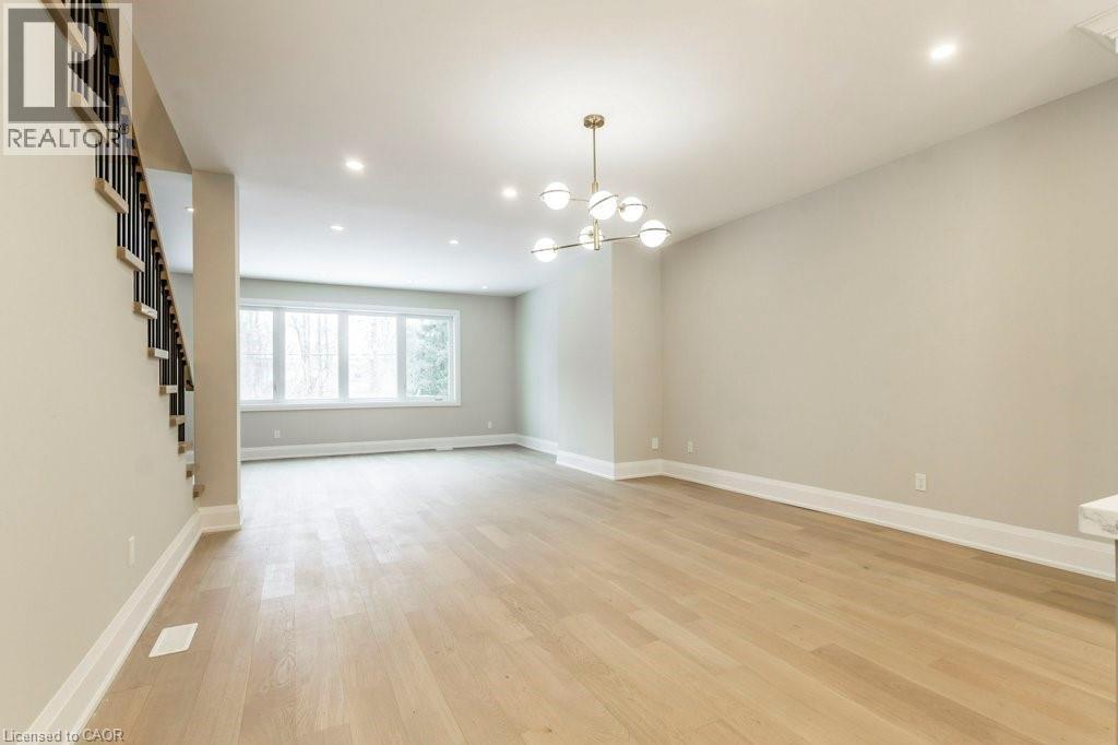 Unfurnished room with a chandelier and light wood-style flooring - 1105 Main Street E, Cambridge, ON - Indoor Photo Showing Other Room