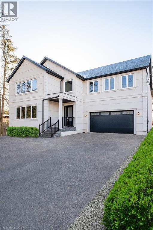 Modern farmhouse with an attached garage and driveway - 1105 Main Street E, Cambridge, ON - Outdoor