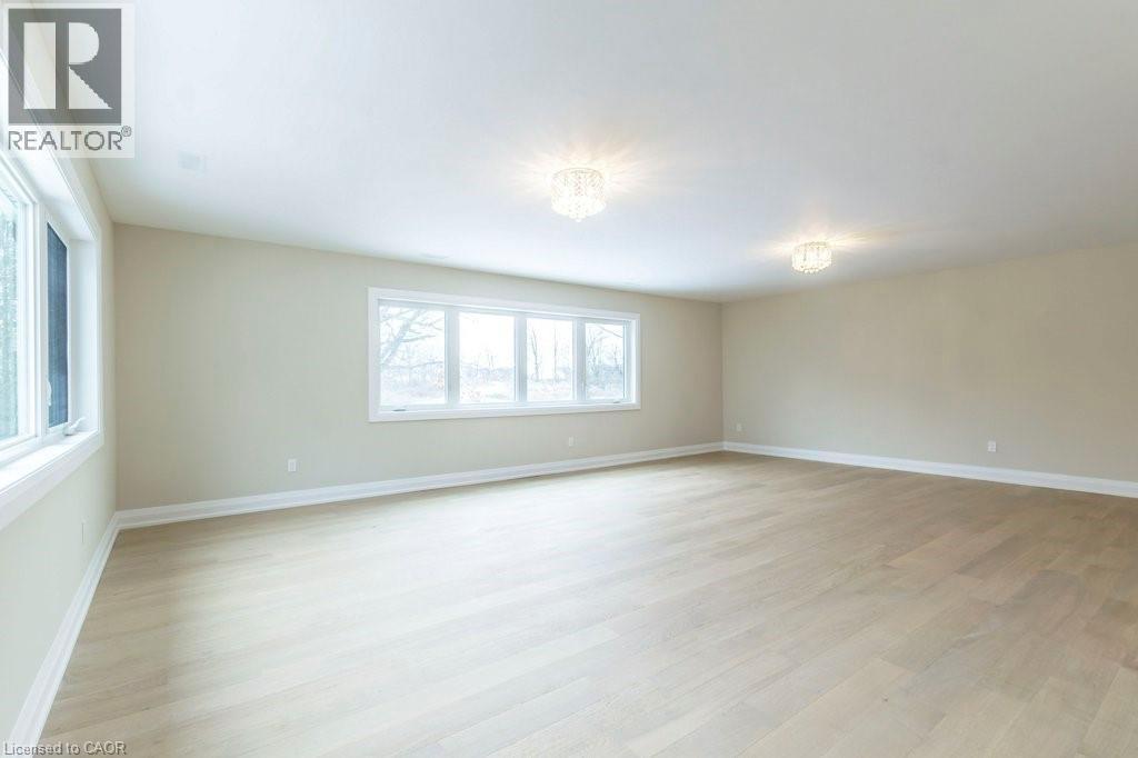 Empty room with light wood finished floors - 1105 Main Street E, Cambridge, ON - Indoor Photo Showing Other Room