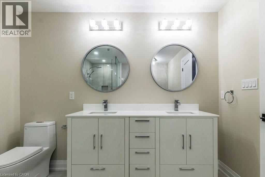 Full bathroom featuring double vanity and a marble finish shower - 1105 Main Street E, Cambridge, ON - Indoor Photo Showing Bathroom