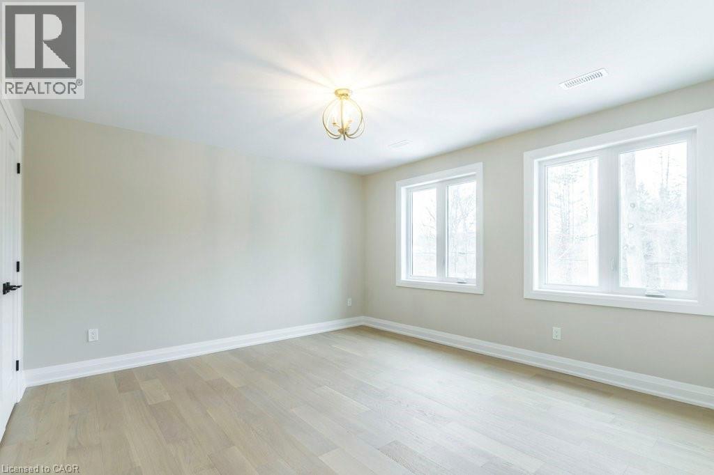 Unfurnished room with light wood-type flooring and a chandelier - 1105 Main Street E, Cambridge, ON - Indoor Photo Showing Other Room