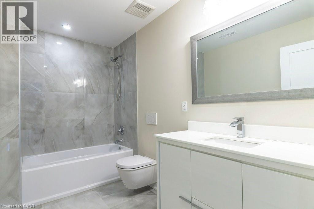 Full bathroom with vanity, shower combination, and light marble finish floors - 1105 Main Street E, Cambridge, ON - Indoor Photo Showing Bathroom