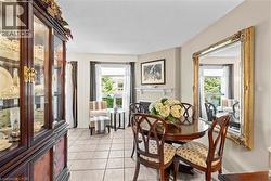 Dining area featuring ceramic tile flooring, a built-in fireplace with a mantel, and perimeter windows -