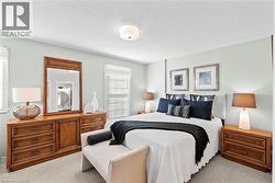 Carpeted bedroom featuring light-colored walls and a textured ceiling -