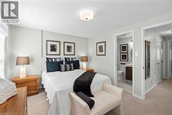 Carpeted sleeping area with light-toned walls and a window with white louvered blinds -