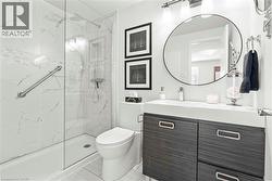 Contemporary bathroom featuring a walk-in shower with marble-look wall tiles and a glass enclosure -