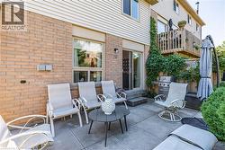 Concrete patio with brick and siding exterior -