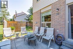 Expansive outdoor patio featuring concrete pavers and a brick exterior -