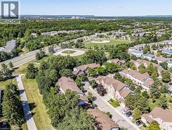 Aerial perspective showcasing a residential community with abundant mature trees and green spaces -