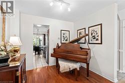 Hardwood flooring complements the bright white walls and track lighting -