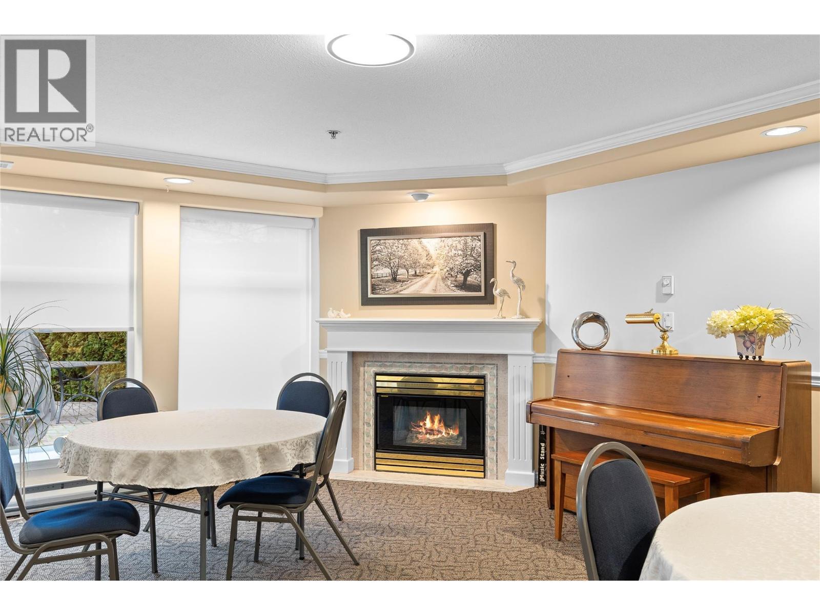 3300 Centennial Drive Unit# 204, Vernon, BC - Indoor Photo Showing Dining Room With Fireplace