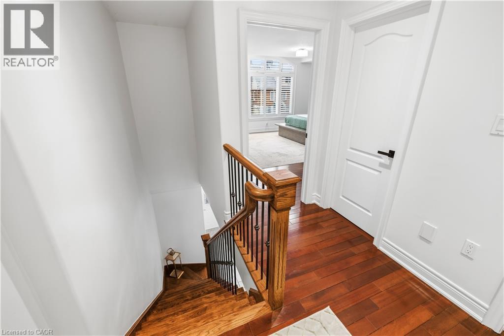 Hardwood flooring and a staircase with wood newel post and balusters - 199 Hunter Street W, Hamilton, ON - Indoor Photo Showing Other Room