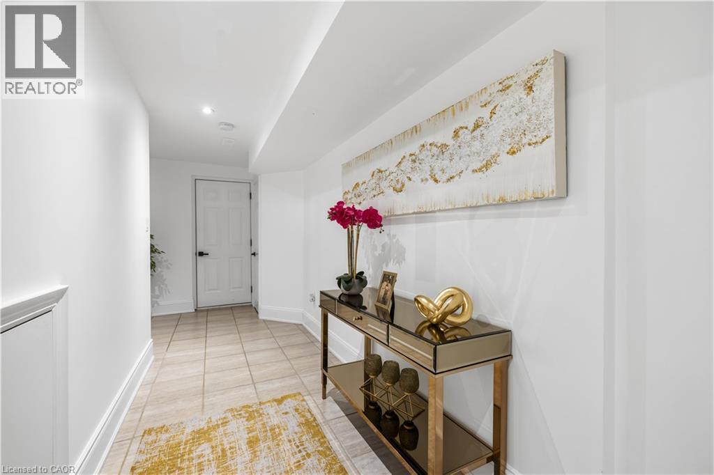 Hallway featuring light-toned square tile flooring and white baseboards - 199 Hunter Street W, Hamilton, ON - Indoor Photo Showing Other Room