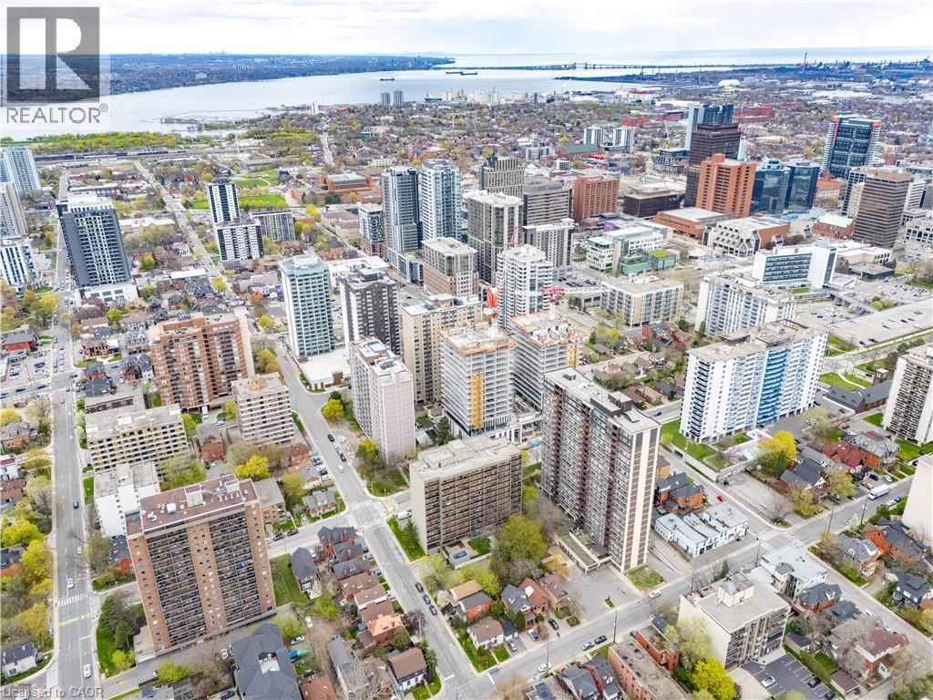 Aerial perspective showcasing a vibrant urban landscape with diverse architectural styles, including high-rise residential buildings and commercial structures - 199 Hunter Street W, Hamilton, ON - Outdoor With View
