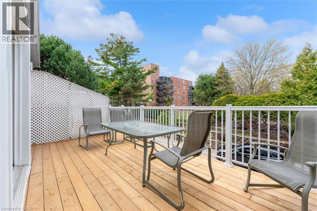 Wood-finish deck with white railings and a lattice privacy screen - 1389 Lakeshore Road, Burlington, ON - Outdoor With Deck Patio Veranda With Exterior