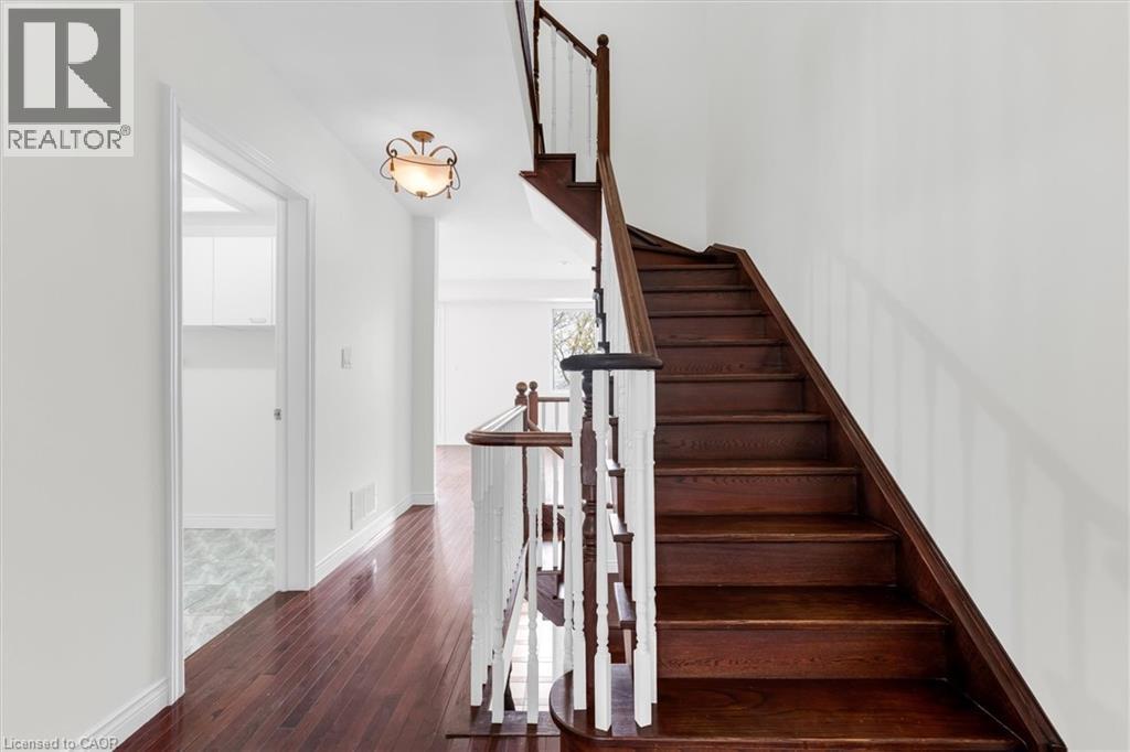Hardwood staircase with white balusters and dark wood treads - 1389 Lakeshore Road, Burlington, ON - Indoor Photo Showing Other Room