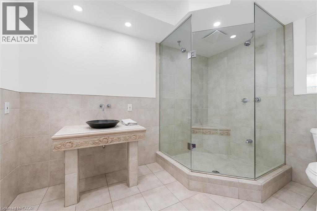 Glass-enclosed shower with a built-in bench, dual shower heads, and recessed lighting - 1389 Lakeshore Road, Burlington, ON - Indoor Photo Showing Bathroom