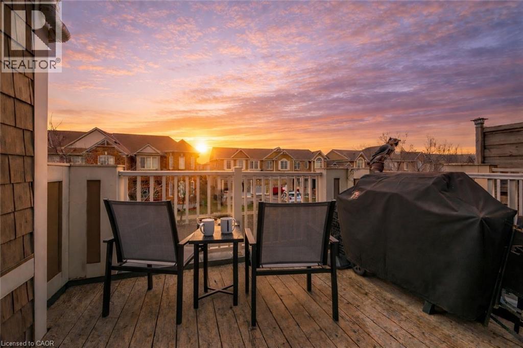 Exterior deck with wood-finish flooring and white railings - 525 Cavanagh Lane, Milton, ON - Outdoor