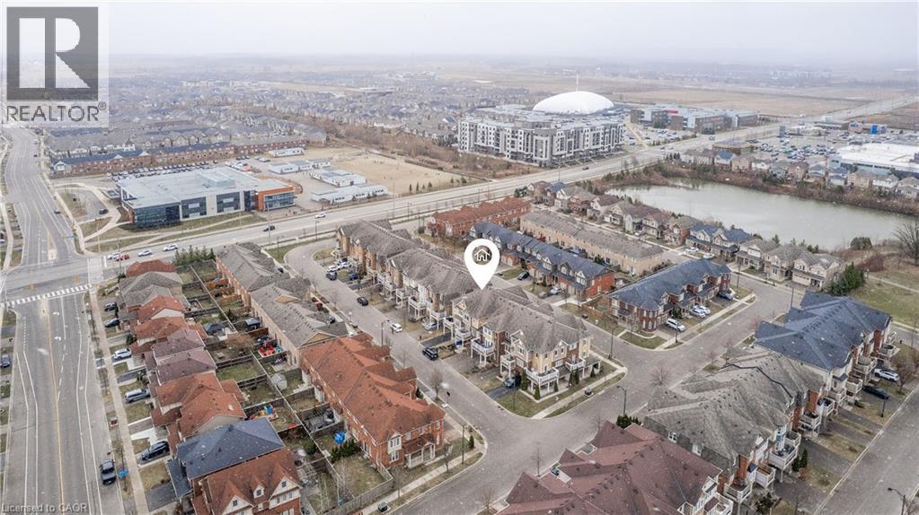 Aerial perspective showcasing a residential development with varied housing styles - 525 Cavanagh Lane, Milton, ON - Outdoor With View