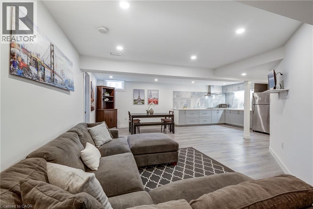 Open-concept living space with recessed lighting and light wood-finish flooring - 29 Wiltshire Place, Ancaster, ON - Indoor Photo Showing Living Room