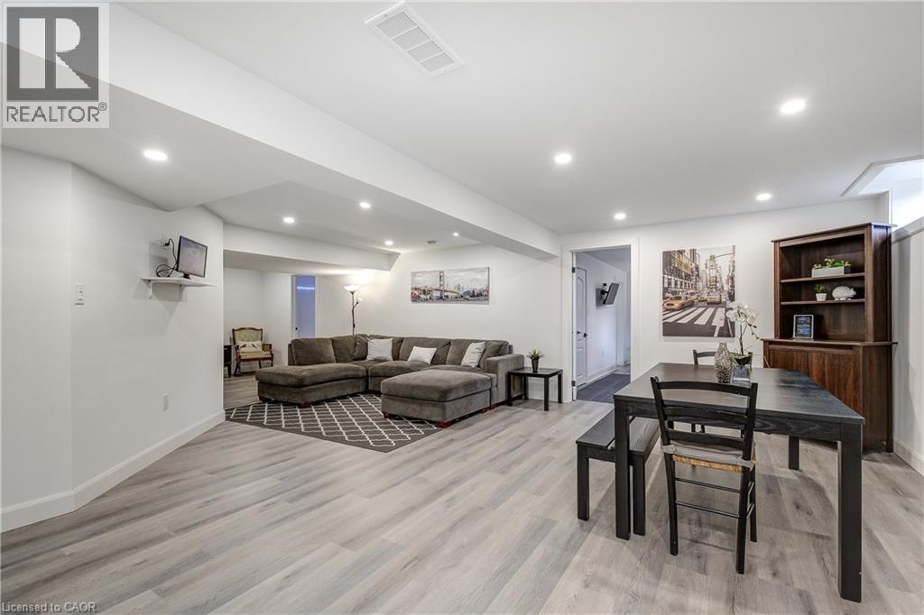 Open-concept lower level featuring recessed lighting and wood-finish flooring - 29 Wiltshire Place, Ancaster, ON - Indoor