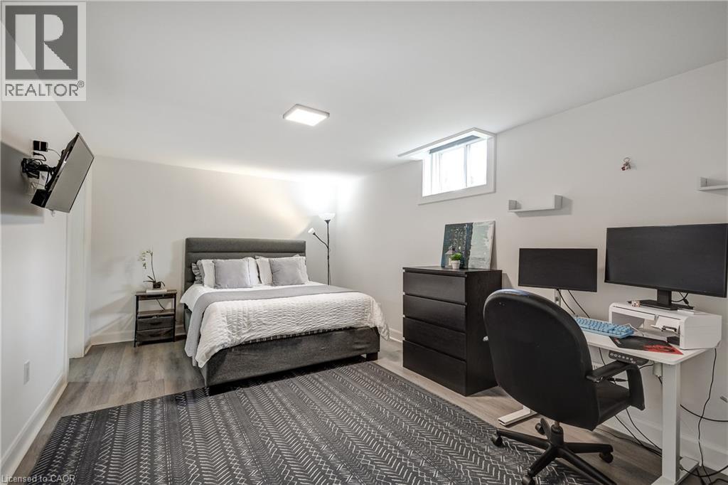 Room featuring wood-finish flooring, a neutral color palette, recessed ceiling lighting, and a window providing natural illumination - 29 Wiltshire Place, Ancaster, ON - Indoor