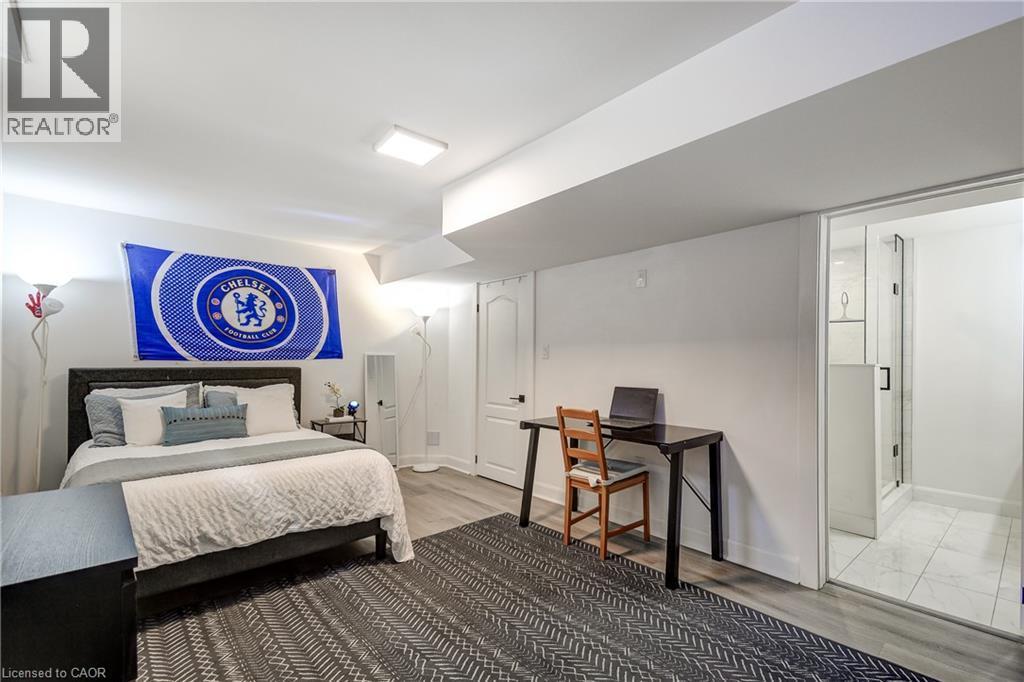 Finished room with wood-finish flooring, recessed lighting, and a glass-enclosed shower featuring white tile flooring - 29 Wiltshire Place, Ancaster, ON - Indoor Photo Showing Bedroom