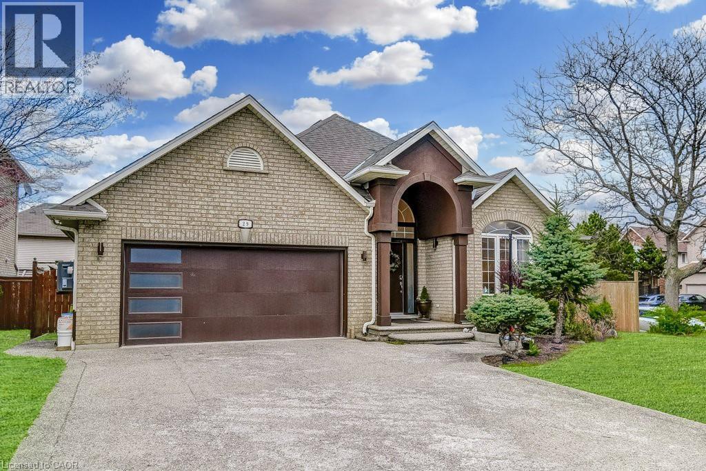 Light-toned brick exterior with a prominent arched entry - 29 Wiltshire Place, Ancaster, ON - Outdoor With Facade