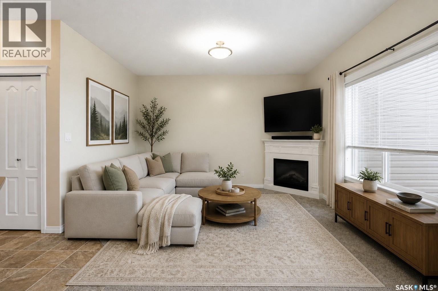 210 3818 Dewdney Avenue E, Regina, SK - Indoor Photo Showing Living Room With Fireplace