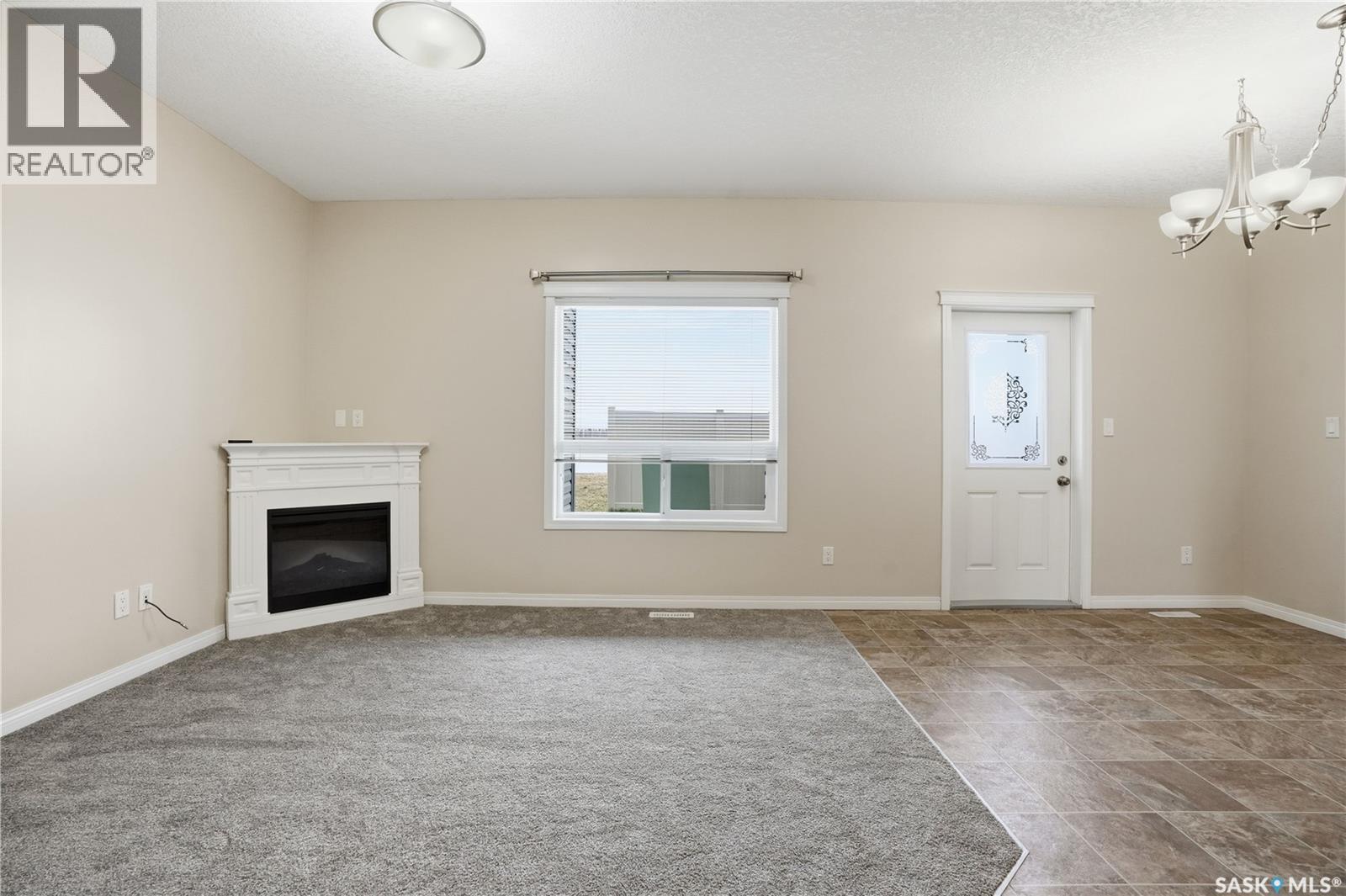 210 3818 Dewdney Avenue E, Regina, SK - Indoor Photo Showing Other Room With Fireplace