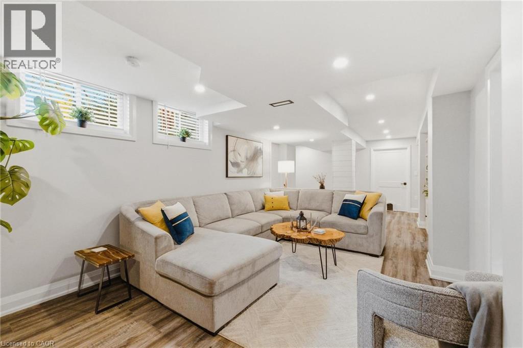 Spacious room featuring wood-finish flooring, recessed lighting, and bright white walls - 120 Elgin Crescent, Waterloo, ON - Indoor Photo Showing Living Room