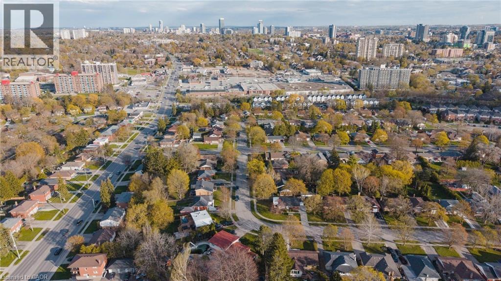 Aerial depiction of a residential neighborhood with tree-lined streets, single-story homes, and multi-story apartment buildings - 120 Elgin Crescent, Waterloo, ON - Outdoor With View