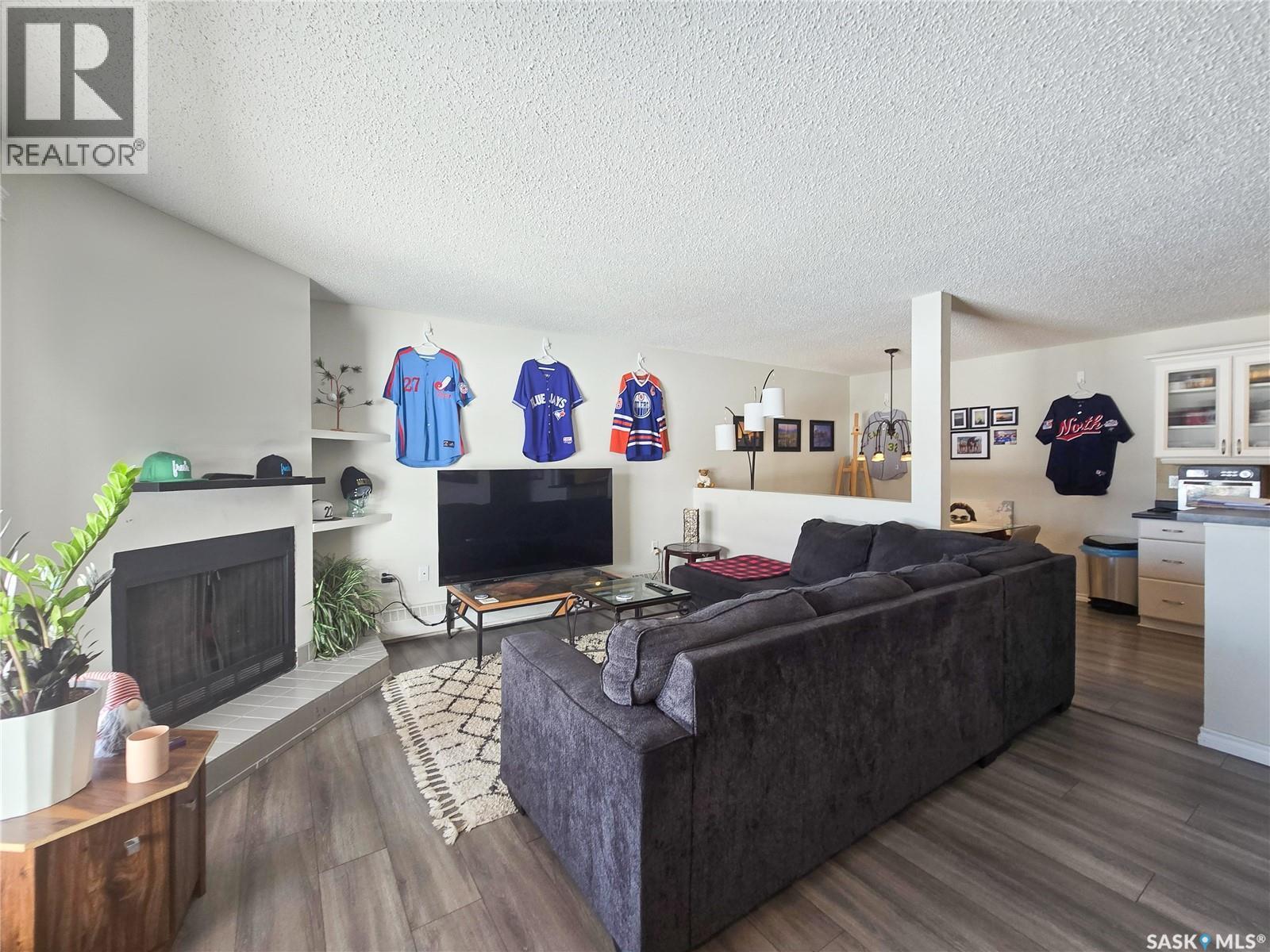 108 2931 Harding Street, Regina, SK - Indoor Photo Showing Living Room With Fireplace