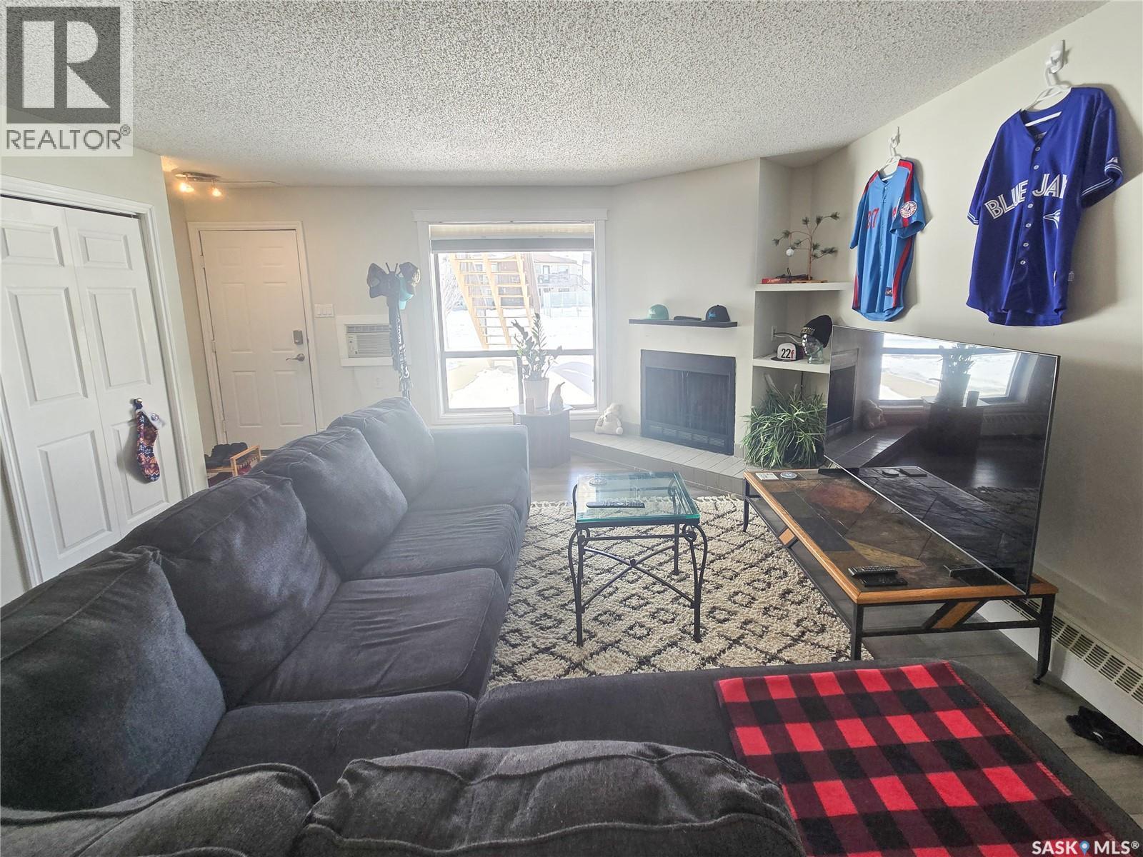 108 2931 Harding Street, Regina, SK - Indoor Photo Showing Living Room With Fireplace