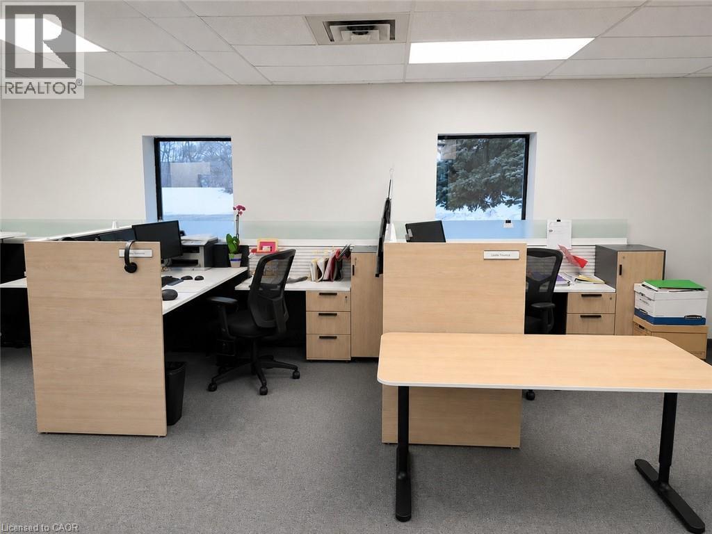 Open office area featuring recessed lighting, a drop tile ceiling, and two windows - 920 Sheldon Court, Burlington, ON
