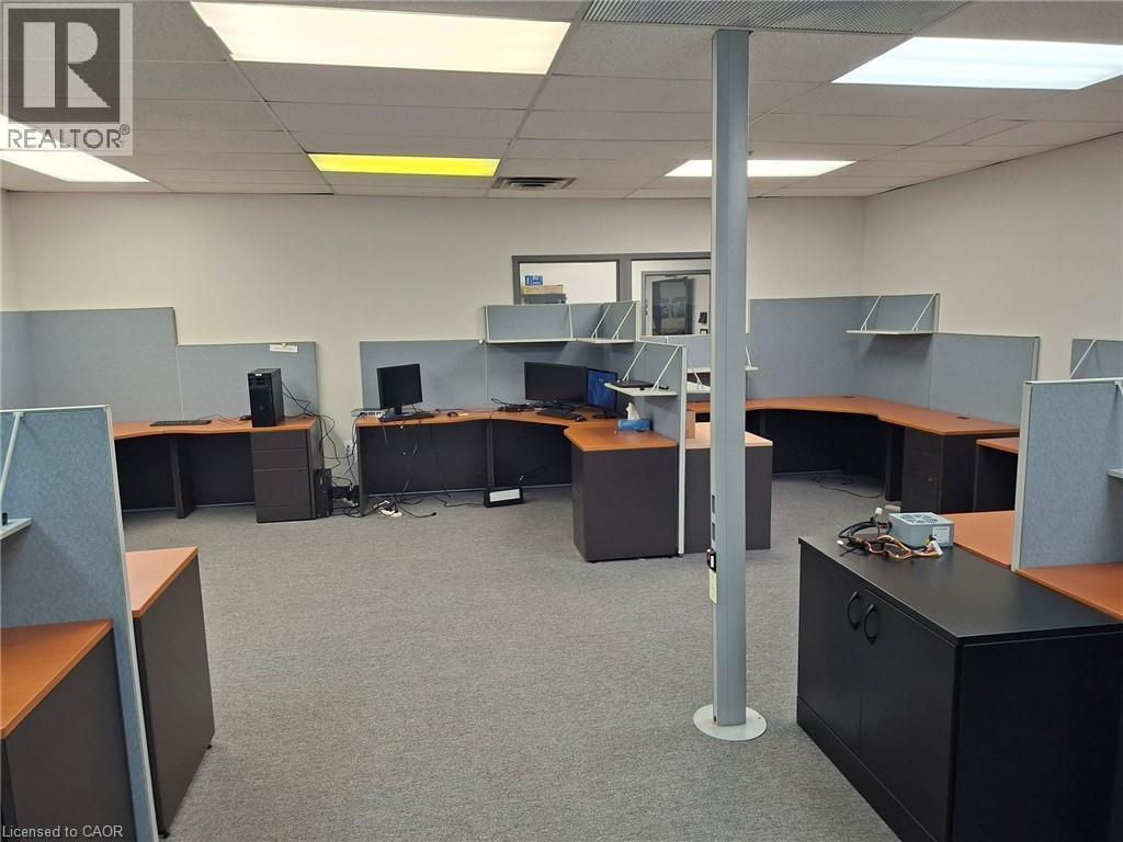 Open commercial space with textured carpet flooring, acoustical ceiling tiles, and white walls - 920 Sheldon Court, Burlington, ON