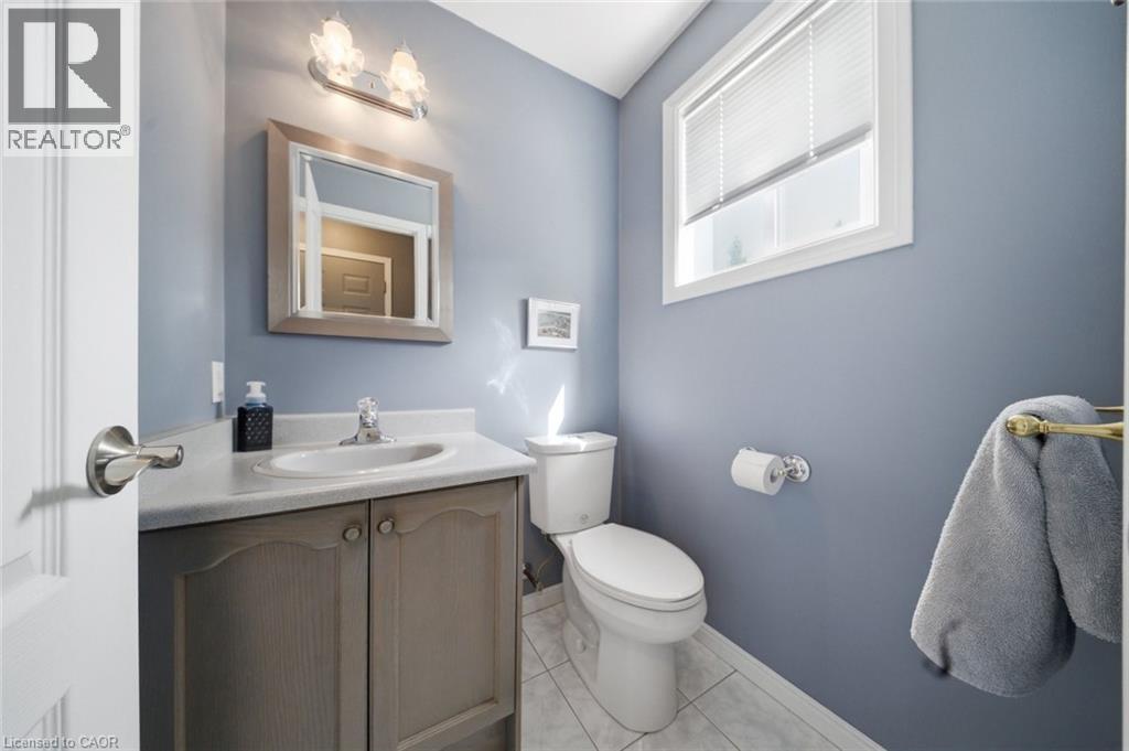 Bathroom featuring a single vanity with a white countertop, light grey cabinetry, and a chrome faucet - 200 Morrison Drive, Caledonia, ON - Indoor Photo Showing Bathroom