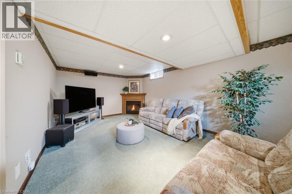 Recreation room featuring a fireplace with a wood mantel, light-colored walls, recessed lighting, and a drop ceiling - 200 Morrison Drive, Caledonia, ON - Indoor