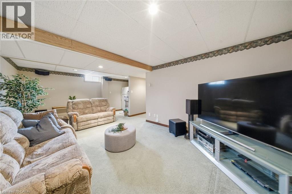 Carpeted recreation area featuring a drop ceiling with recessed lighting and a wood beam accent - 200 Morrison Drive, Caledonia, ON - Indoor