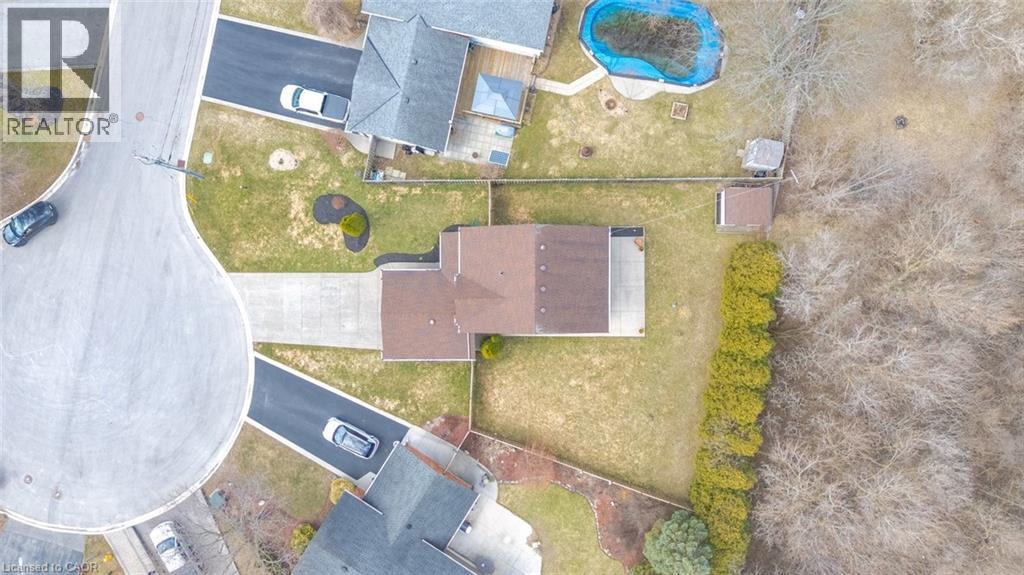 Aerial perspective showcasing the property with a private driveway, a structured roofline, an expansive backyard, and dense perimeter landscaping - 200 Morrison Drive, Caledonia, ON - With View