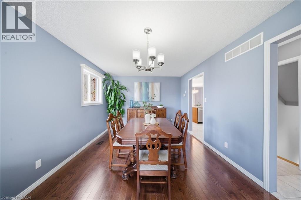Wood-finish flooring throughout, featuring a white trim baseboard - 200 Morrison Drive, Caledonia, ON - Indoor Photo Showing Dining Room