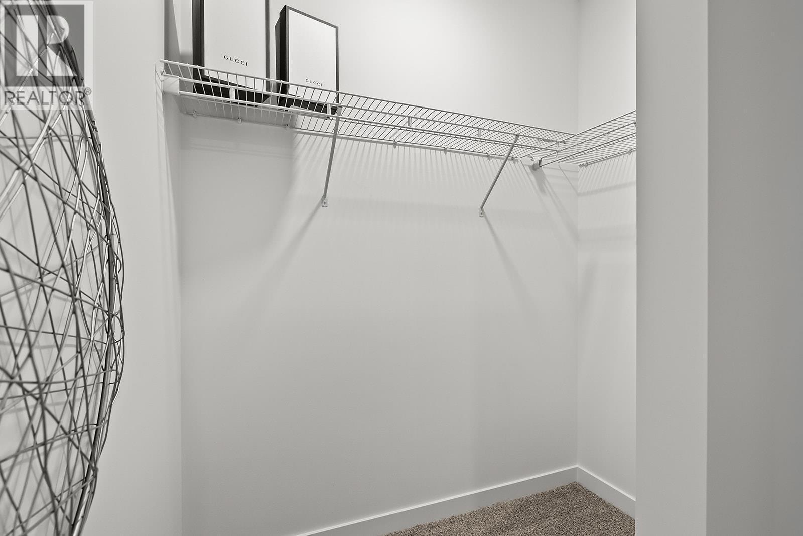 Primary Walk-in Closet. Photos may be of a similar home in the community. - 1057 Frost Road Unit# 418, Kelowna, BC - Indoor With Storage