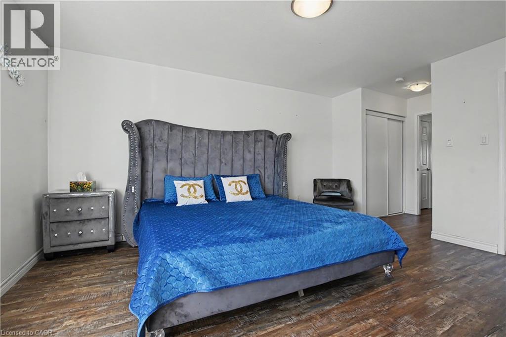 Spacious room featuring wood-finish flooring, white walls, and a ceiling-mounted light fixture - 60 Postmaster Drive, Kitchener, ON - Indoor Photo Showing Bedroom