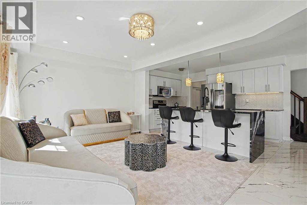Open-concept living space with recessed lighting and a decorative chandelier - 60 Postmaster Drive, Kitchener, ON - Indoor Photo Showing Other Room