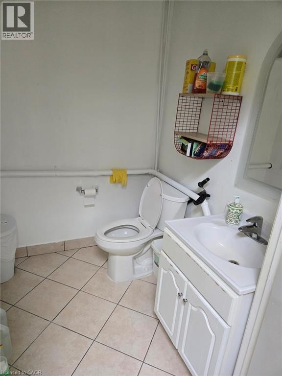 Bathroom featuring a white vanity with integrated sink, chrome faucet, and tiled flooring - 9688 Leslie Street Unit# 16, Richmond Hill, ON