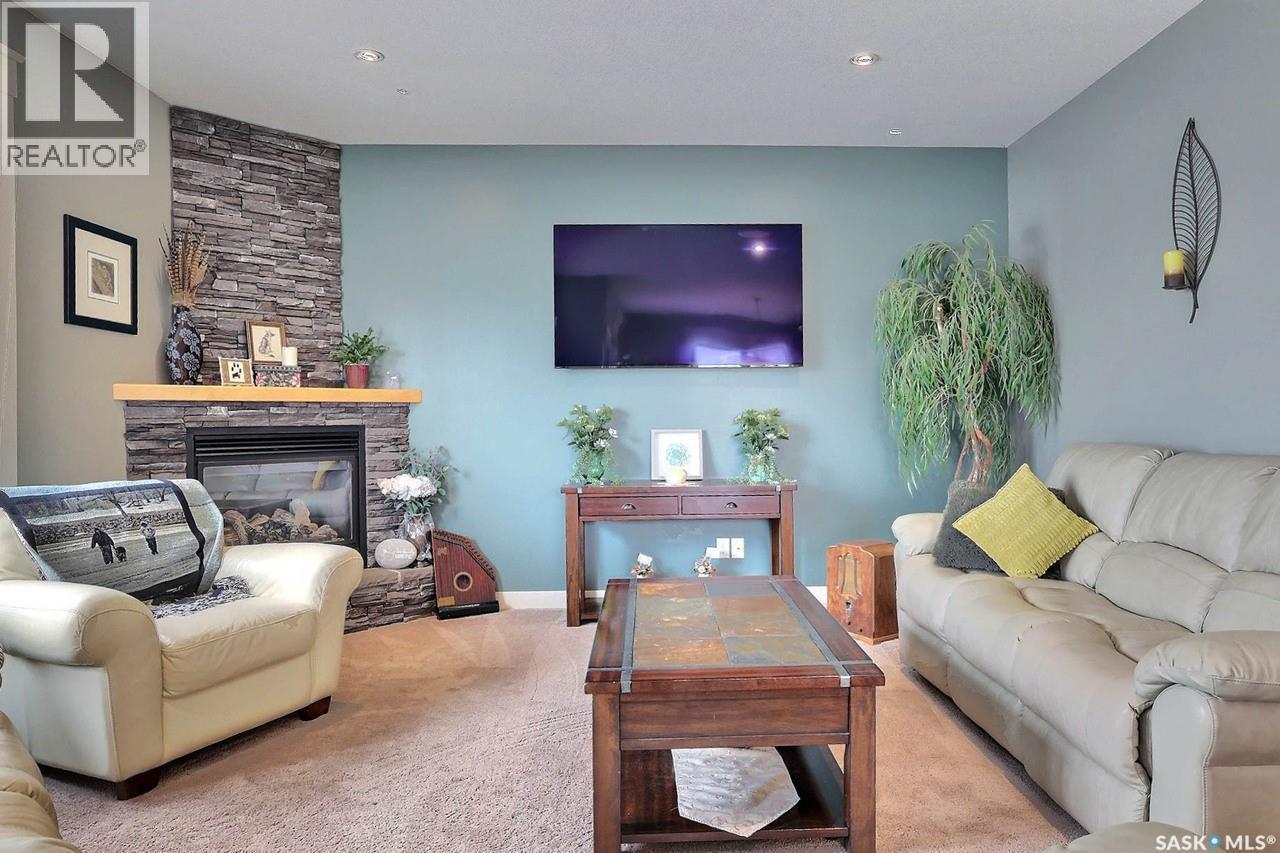 225 Willow Ridge Drive, Pilot Butte, SK - Indoor Photo Showing Living Room With Fireplace